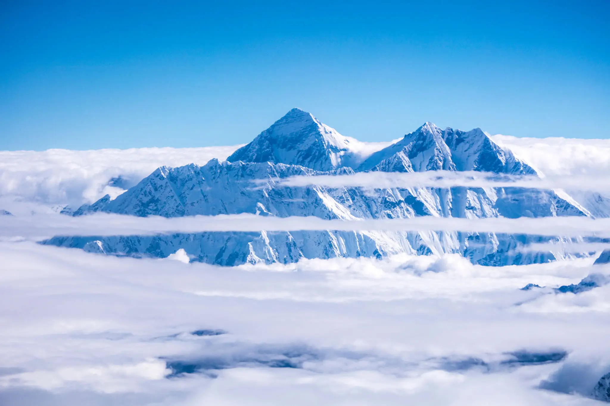 Blue sky over snowy mountain peaks