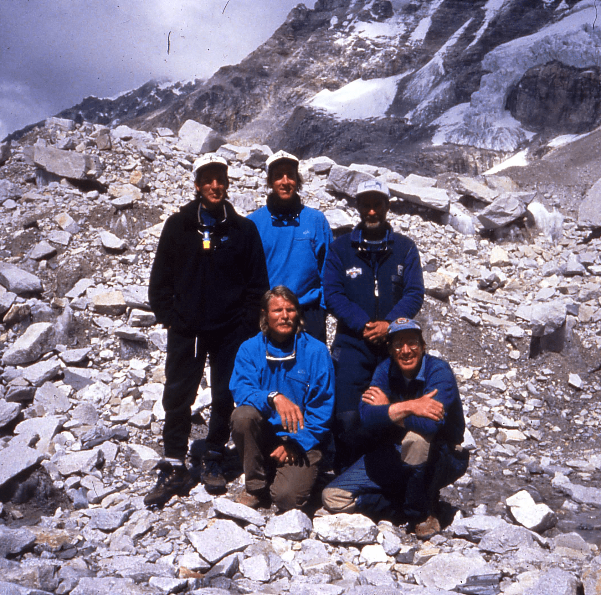 Group posing on rocky mountain terrain