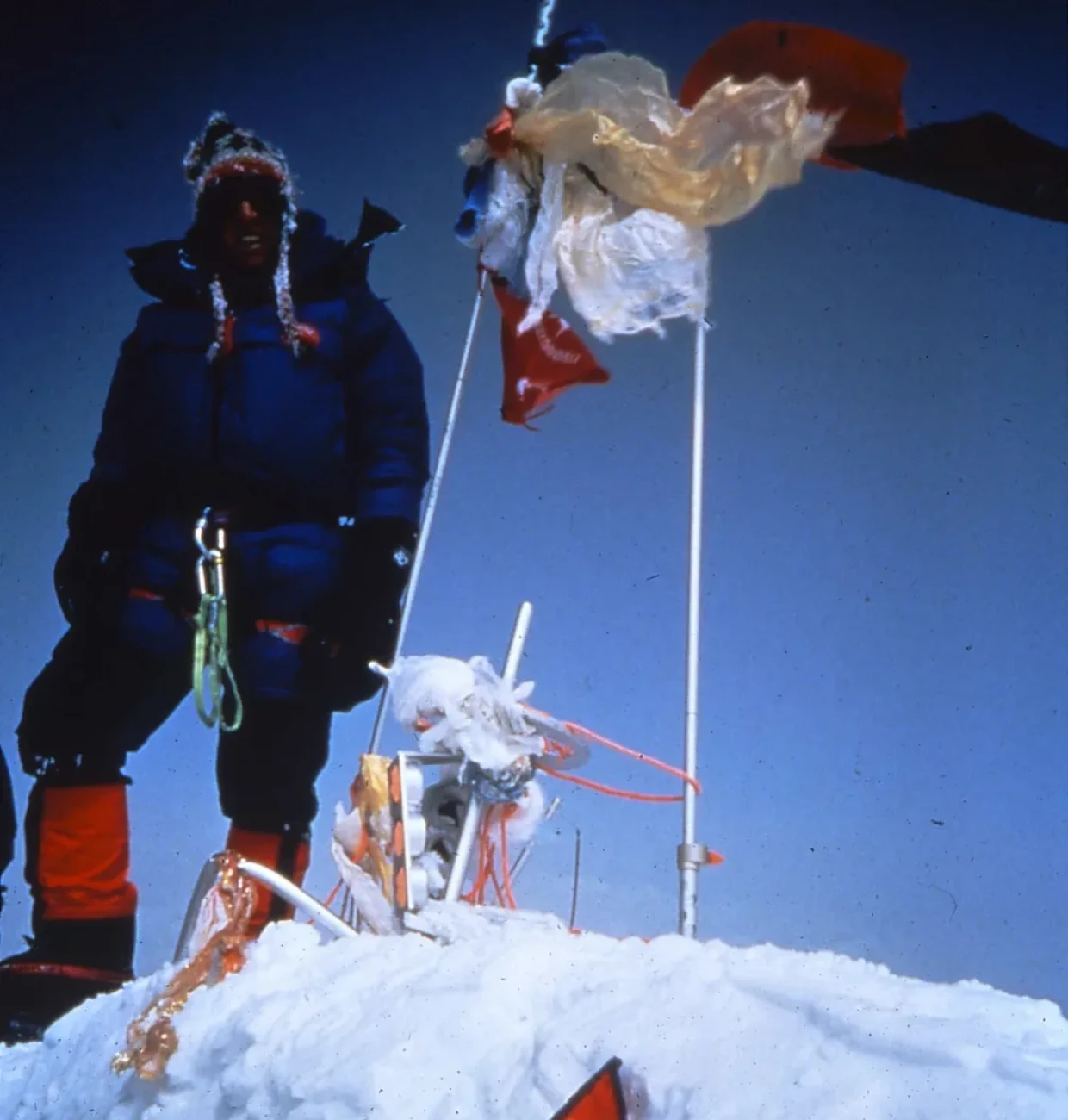 Climber standing on snow-covered peak