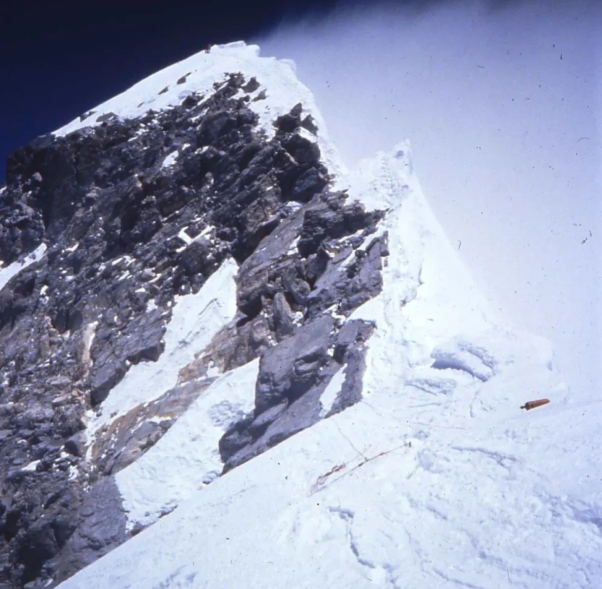 Icy mountain ridge against blue backdrop
