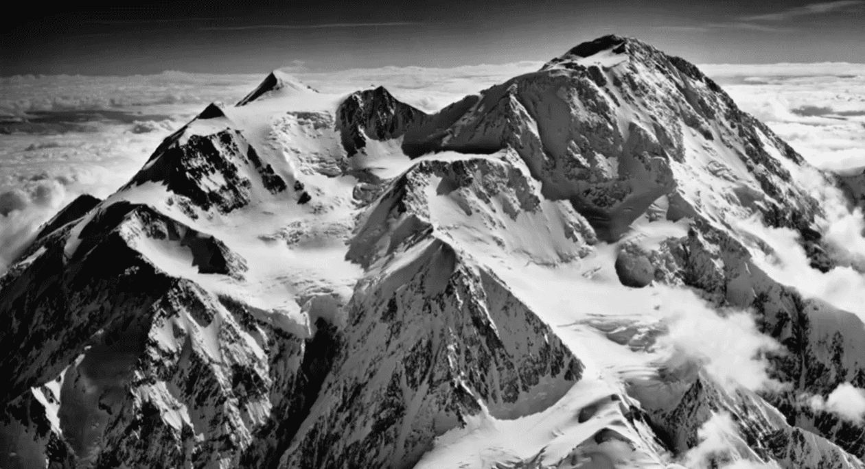 Snow-covered mountain peaks under a clear sky.