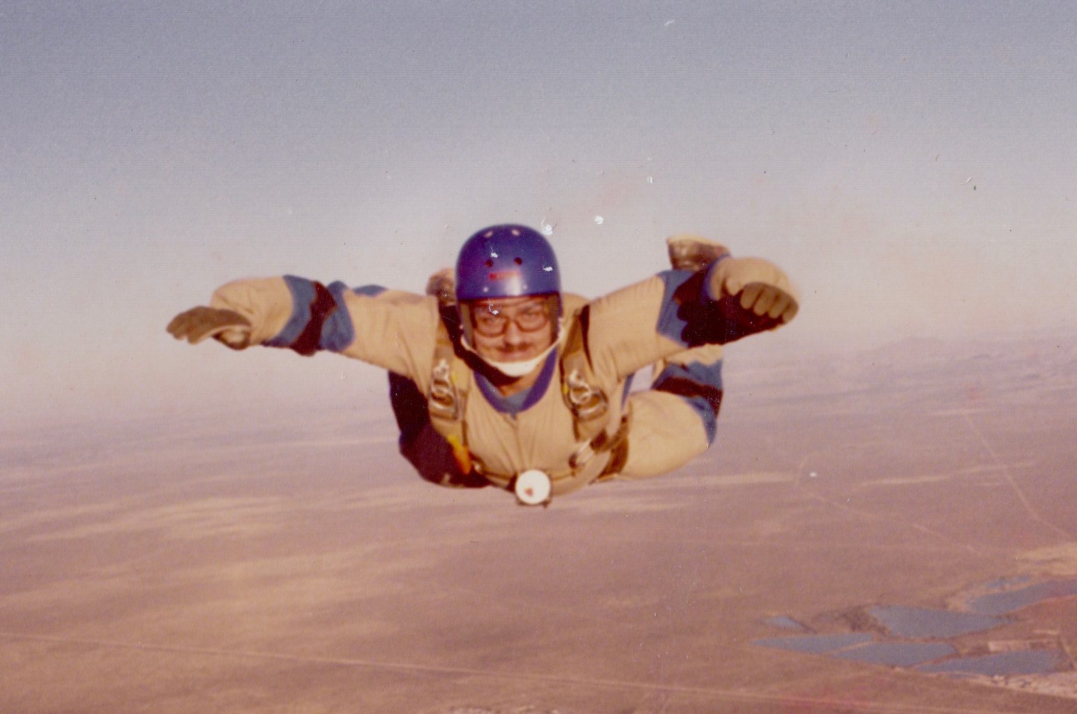 A person skydiving with a helmet and goggles.